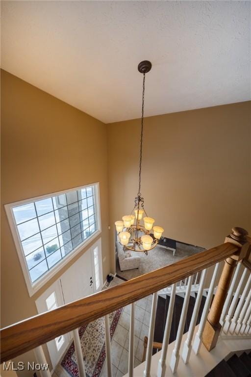 stairway with an inviting chandelier