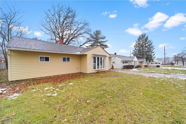 back of house featuring a yard