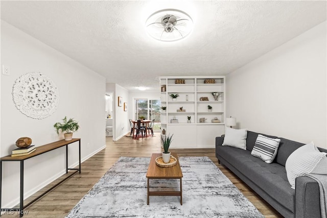 living room featuring dark hardwood / wood-style floors and a textured ceiling