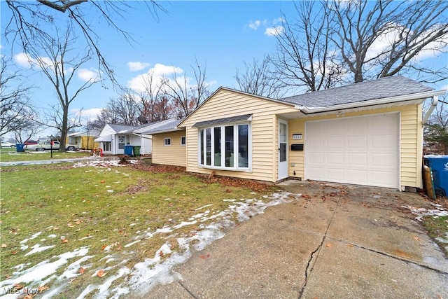 ranch-style house with a garage and a front lawn