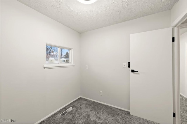 empty room featuring carpet flooring and a textured ceiling