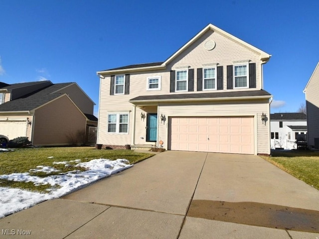 view of front of property with a garage and a front lawn