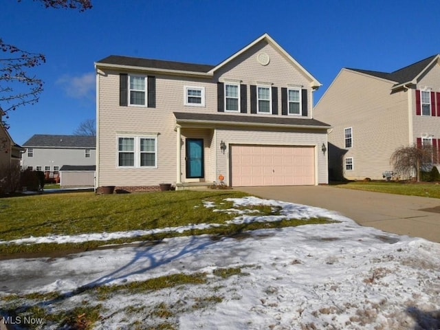 view of front of property with a garage and a yard