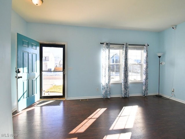 spare room with dark wood-type flooring