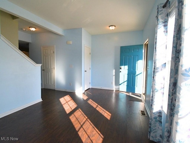 spare room with dark wood-type flooring