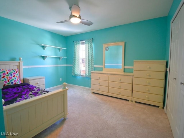 carpeted bedroom with a closet and ceiling fan