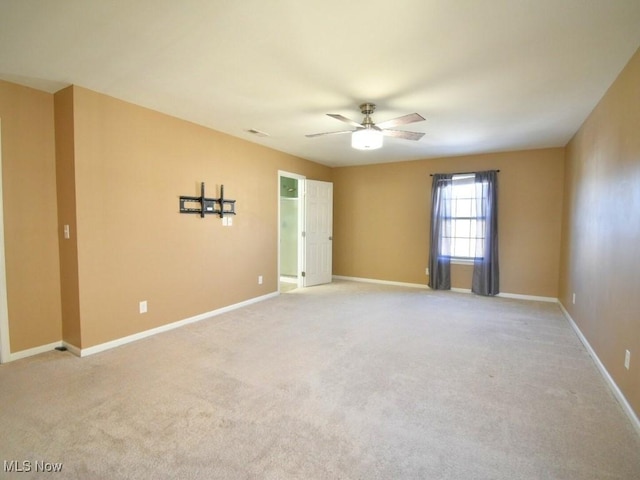 empty room with light colored carpet and ceiling fan