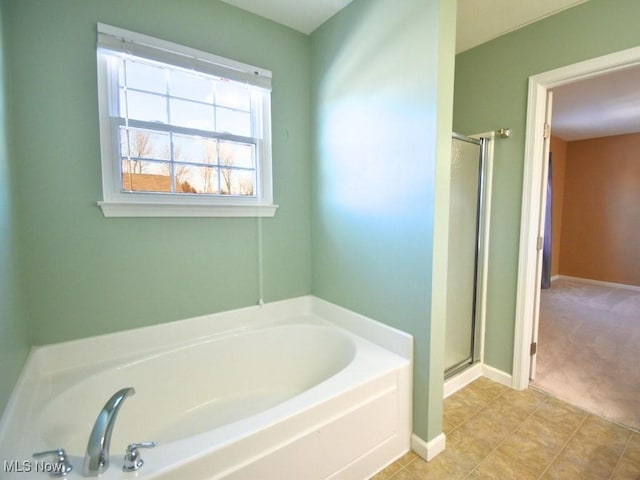 bathroom with tile patterned flooring and plus walk in shower