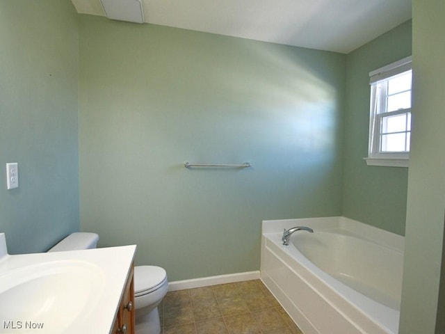 bathroom with a washtub, vanity, tile patterned floors, and toilet