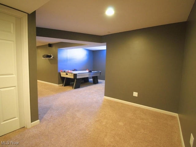 game room featuring light carpet