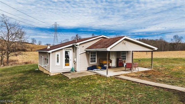 view of front of house with a patio area and a front yard