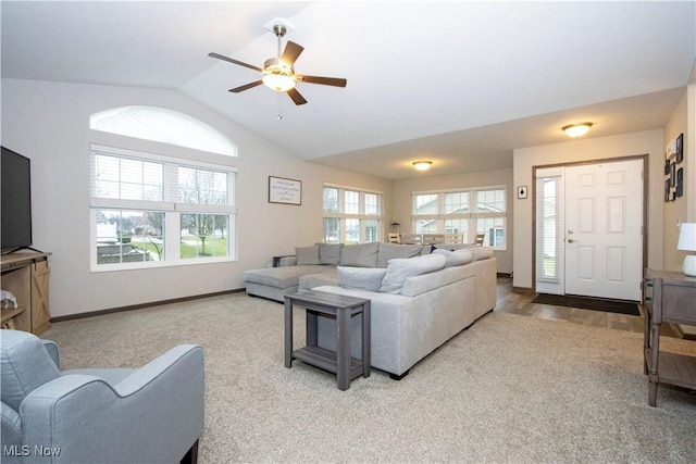 living room featuring carpet floors, vaulted ceiling, and ceiling fan