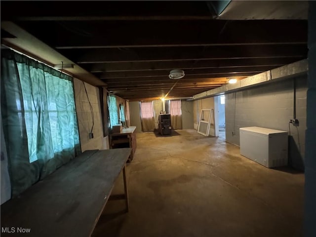 basement with refrigerator and heating unit