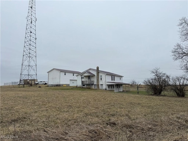 rear view of house with a yard