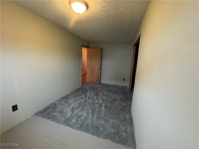 spare room with a textured ceiling