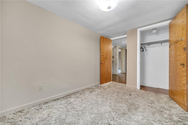 unfurnished bedroom featuring carpet floors and a closet