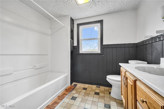 full bathroom featuring vanity, toilet, shower / washtub combination, and a textured ceiling