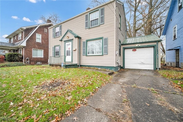 view of front of home with a garage and a front lawn