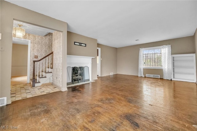 unfurnished living room with wood-type flooring