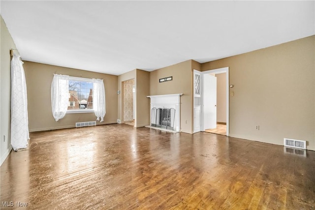 unfurnished living room with hardwood / wood-style flooring