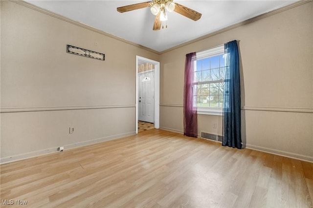 unfurnished room with crown molding, ceiling fan, and light wood-type flooring