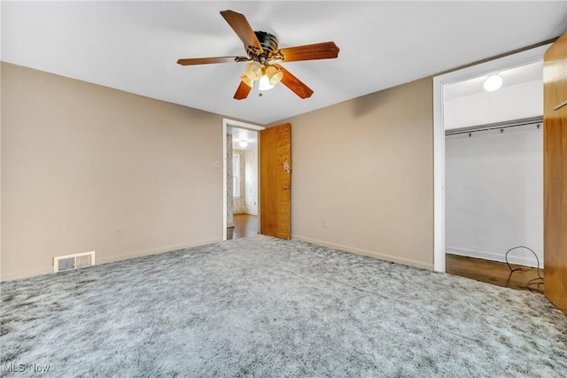 unfurnished bedroom featuring a closet, ceiling fan, and carpet