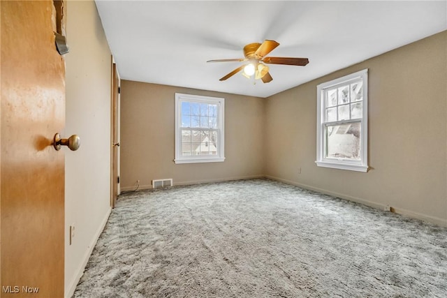 spare room featuring carpet and ceiling fan