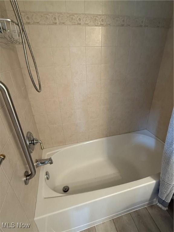 bathroom featuring hardwood / wood-style floors and shower / bath combo