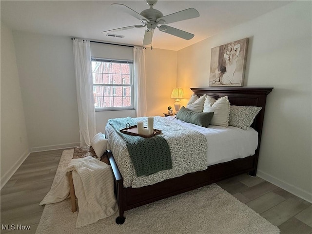 bedroom featuring hardwood / wood-style floors and ceiling fan