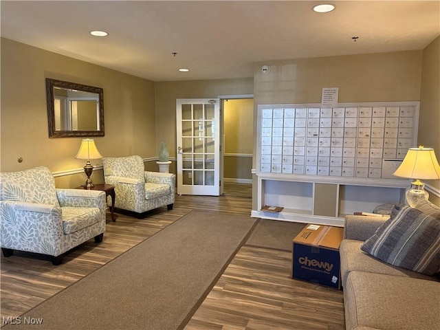 living room with wood-type flooring and mail boxes