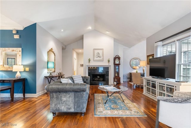 living room featuring lofted ceiling, a fireplace, and dark hardwood / wood-style flooring