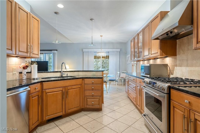 kitchen featuring sink, hanging light fixtures, exhaust hood, and appliances with stainless steel finishes