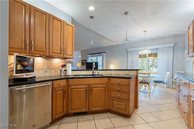 kitchen with hanging light fixtures, stainless steel dishwasher, and kitchen peninsula