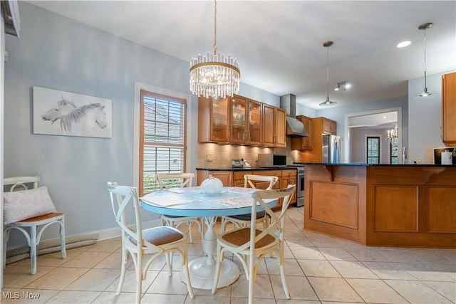 tiled dining area with a chandelier