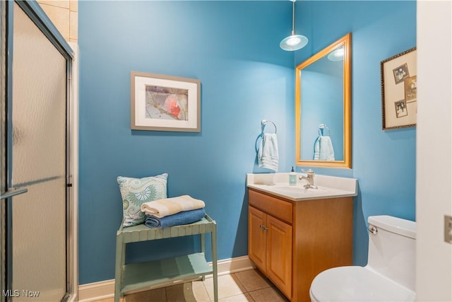 bathroom with tile patterned flooring, vanity, an enclosed shower, and toilet