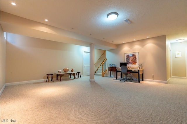 office area featuring light colored carpet and a textured ceiling