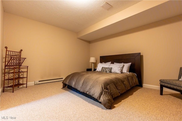 carpeted bedroom with a baseboard radiator and a textured ceiling