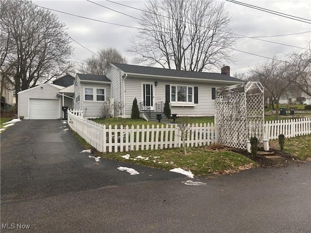 view of front of property with a garage and an outbuilding