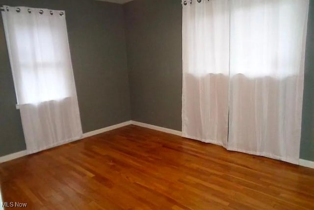 unfurnished room featuring wood-type flooring