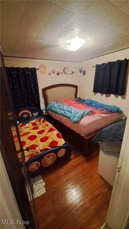 bedroom with wood-type flooring