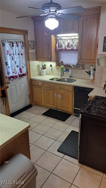 kitchen featuring sink, light tile patterned floors, ceiling fan, black appliances, and decorative backsplash