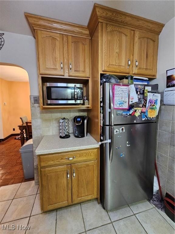 kitchen with stainless steel appliances and light tile patterned floors