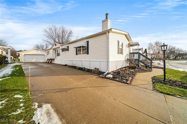 view of home's exterior featuring a garage and an outdoor structure