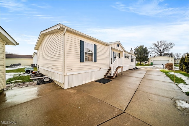 view of home's exterior with a garage and an outdoor structure