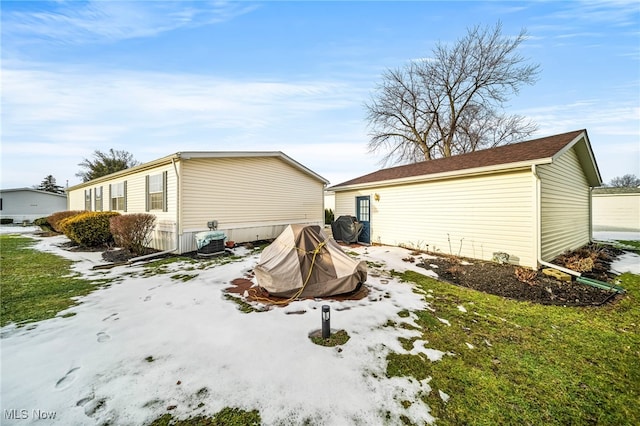 snow covered property with a yard