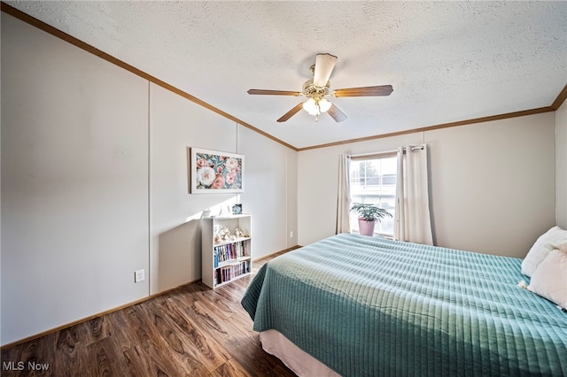 bedroom with hardwood / wood-style flooring, ornamental molding, vaulted ceiling, and a textured ceiling