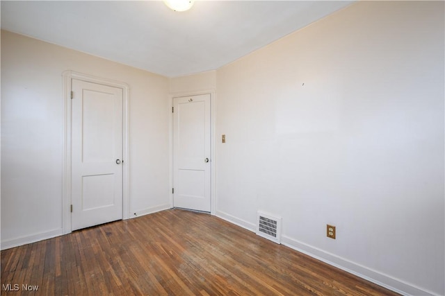 unfurnished room featuring dark hardwood / wood-style flooring