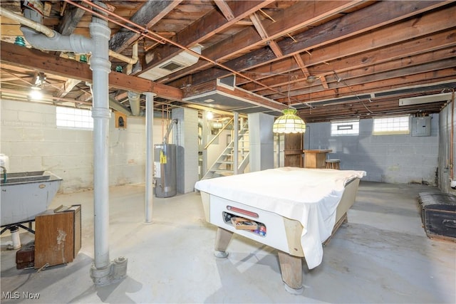 basement featuring billiards, electric panel, sink, and water heater