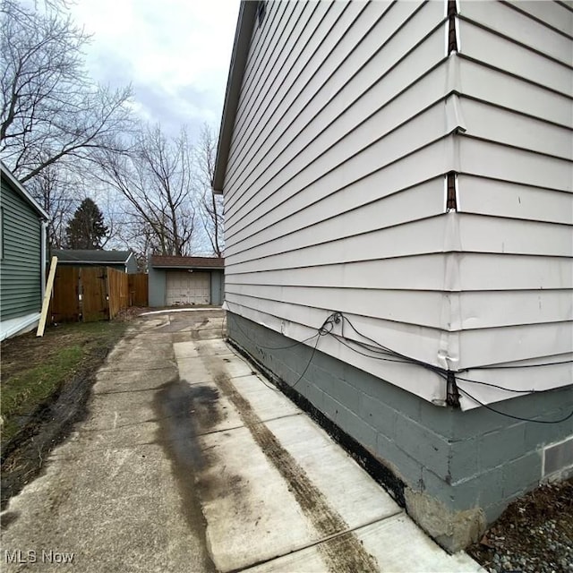 view of property exterior with a garage and an outbuilding