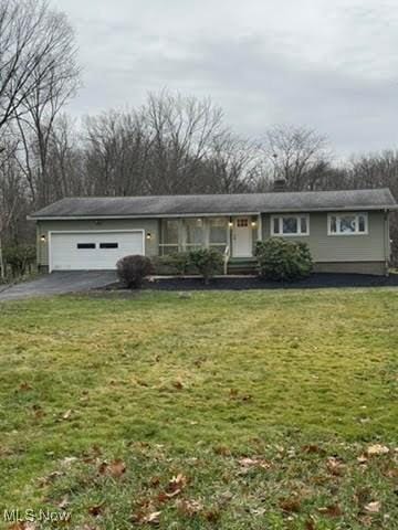 single story home with a garage and a front yard